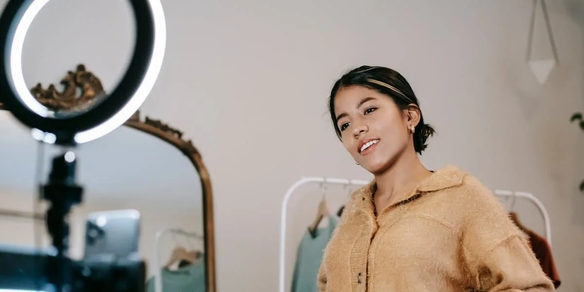 Young fashion influencer recording a video for Instagram with professional lighting.