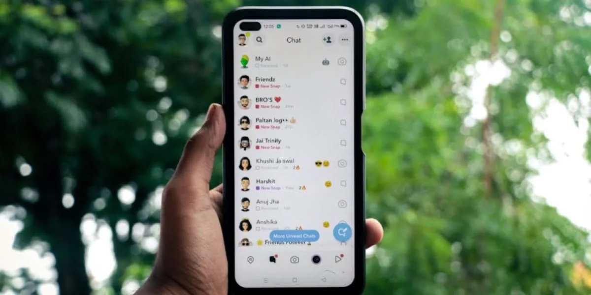 A person holding a cell phone, displaying their contact list on Instagram.